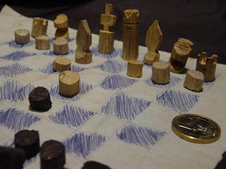 Chess set carved from forest litter during kidnap